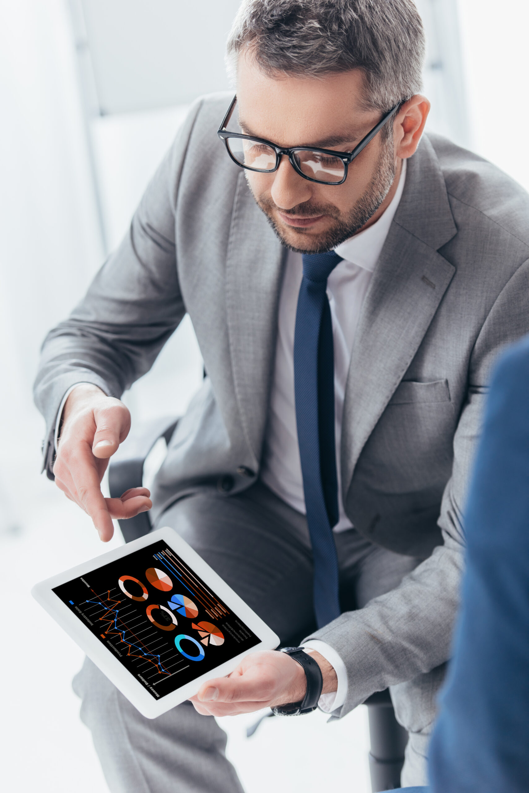 high angle view of handsome businessman in eyeglasses using digital tablet with business charts and high angle view of handsome businessman in eyeglas 2024 11 08 18 47 14 utc scaled