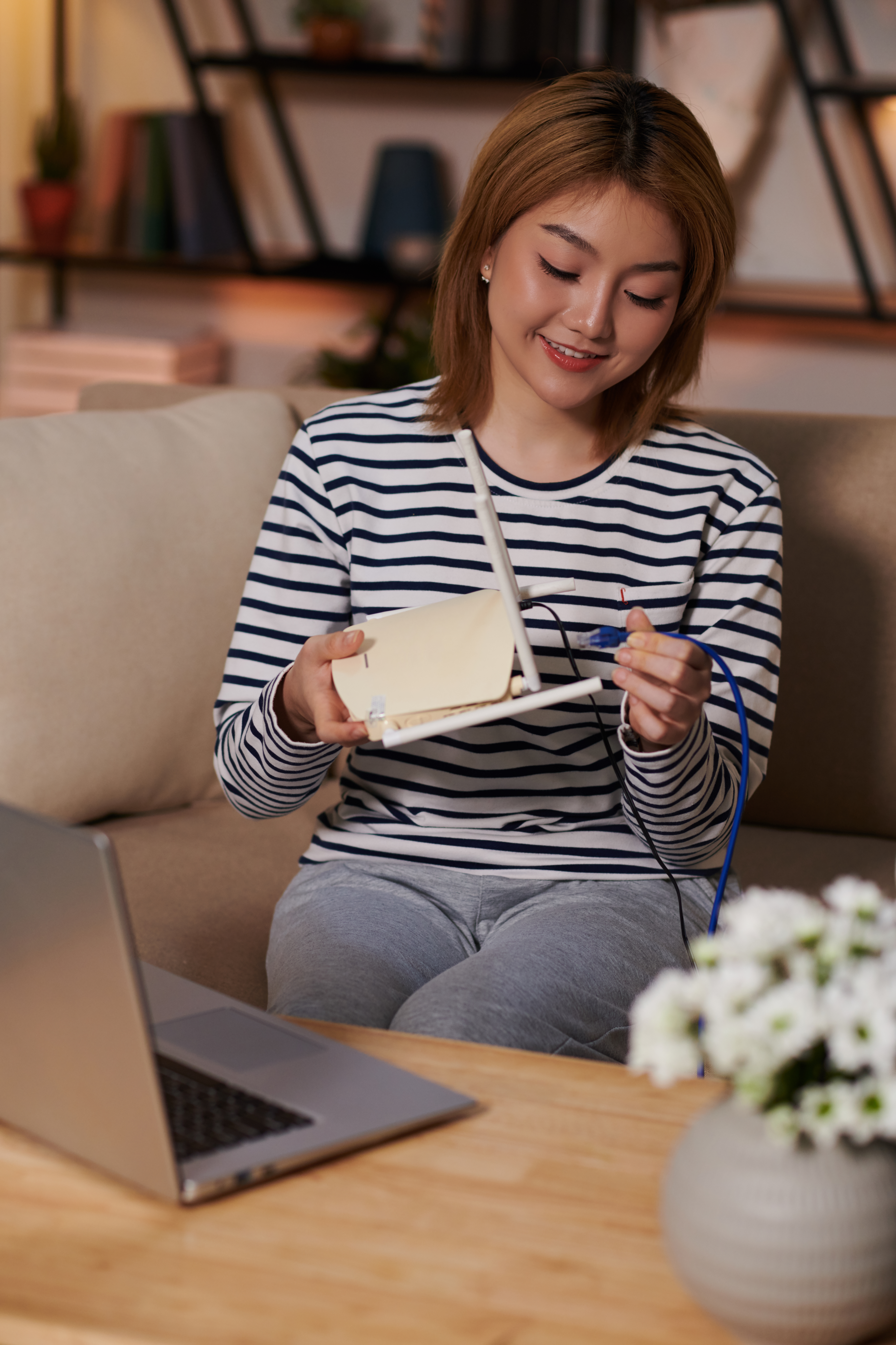woman connecting cord to wireless router 2025 01 31 06 38 04 utc